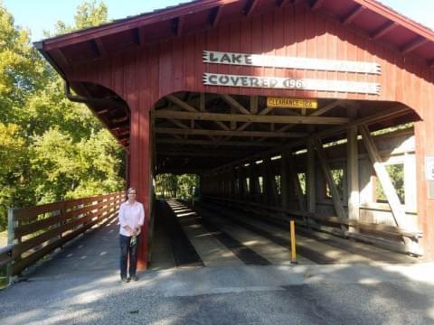 Forest Preserve District executive director Mary Ellen Wuellner stands at the covered bridge over the Sangamon River in Lake of the Woods Forest Preserve. A tax referendum on the Champaign County November 3 ballot would fund a new roof for the bridge, along with other capital projects.