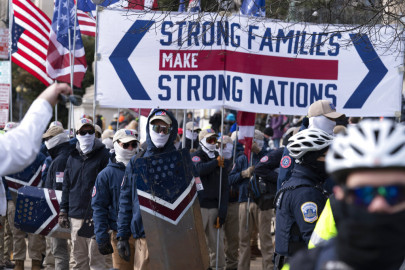 Members of the white supremacist group Patriot Front march on Constitution Avenue near the National Archives in Washington, Friday, Jan. 21, 2022.