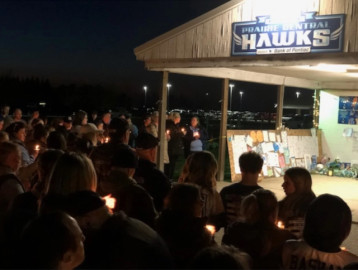 Hundreds of spectators gathered for a prayer vigil at Lewis Field in Fairbury on Saturday night to honor the lives of Drew Fehr and Dylan Bazzell, who died in a ski-related accident last Sunday.