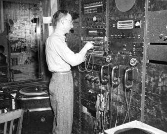 man stands at radio control board