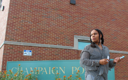 Champaign resident Rita Conerly holds chalk outside the Champaign Police Department building off University Avenue on September 28, 2023. Conerly wrote "Protect Women" outside the department's building after an officer failed to file a report after she made a call regarding domestic violence.