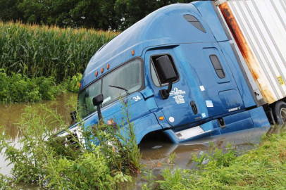 A tractor-trailer lies capsized next to a Jasper County road on Aug. 2, 2022, after flash floods.