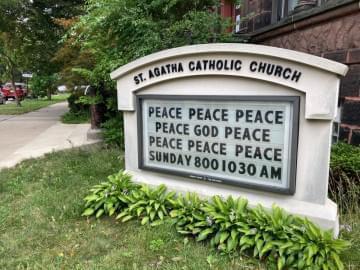 A sign outside of St. Agatha Catholic Church in Chicago's North Lawndale neighborhood expresses an urgent prayer. St. Agatha hosts the READI Chicago program, which is one of several anti-violence efforts showing signs of success despite the city's high shooting numbers.