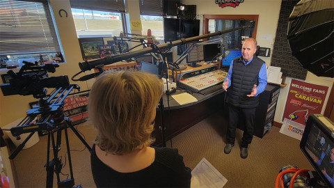 woman interviews man in radio studio