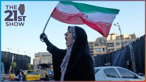 A woman waves an Iranian flags as she chants slogans against Iran and U.S. talks at the Islamic Revolution square in Tehran, Iran, Sunday, June 14, 2026.