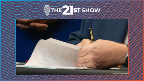 Gov. J.B. Pritzker signs a bill into law.