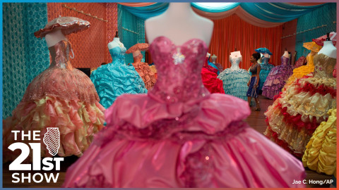 frilly dresses in pink, peach and periwinkle are worn by mannequins in a store with colorful drapery in the backgroud.