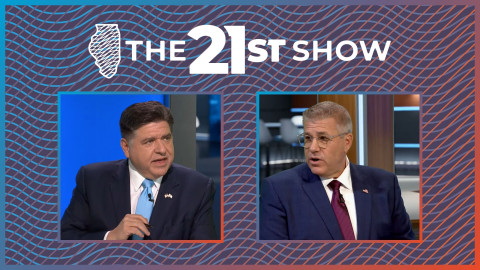 Both Pritzker and Bailey are wearing dark blue suits with white dress shirts and neckties (Pritzker's is light blue, Bailey's is burgundy). Pritzker is holding a pen and making a point. Bailey, wearing clear-frame classes, is talking back.