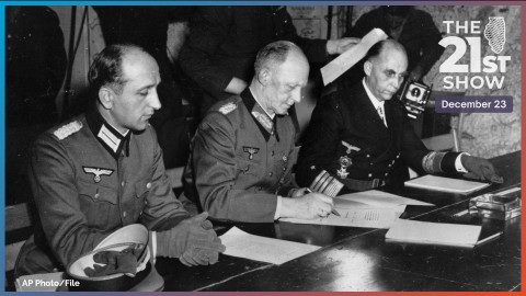 In this May 7, 1945 file photo, Gen. Alfred Jodl, center, signs the unconditional surrender of all German armed forces in a French schoolhouse, ending World War II in Europe and the Holocaust. 