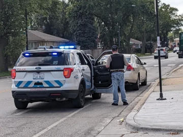 An officer conducts a traffic stop in Austin, a West Side neighborhood that has ranked No. 1 in Chicago in recent years for traffic stops.