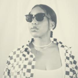 Women poses in checkered jacket and sunglasses 