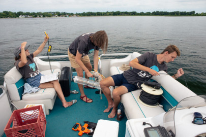 Student employees of the Lilly Center test for toxic algae on Lake Wawasee, the largest natural lake within Indiana. 