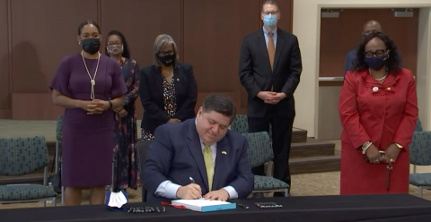 Gov. J.B. Pritzker signs the Illinois Legislative Black Caucus' health care law.