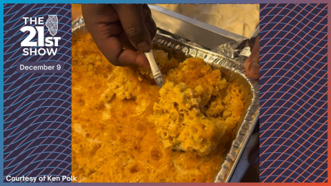 Chef Ken Polk digs into a tray of macaroni and cheese, a classic holiday staple he prepared. 