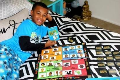 Brennon Hightower's son playing the "My First Matching Game: A Memory Game About African-Americans" at their home in Danville, Ill.