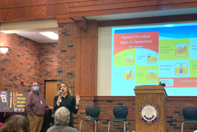Health officials in Columbia, Missouri explain how to administer naloxone at an emergency community meeting. The town has lost 14 people to opioid overdose in the previous four months. 