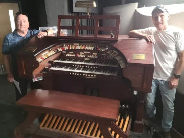 Jim Devitt (left) and Chris Trone, below stage with the Wurlitzer organ.