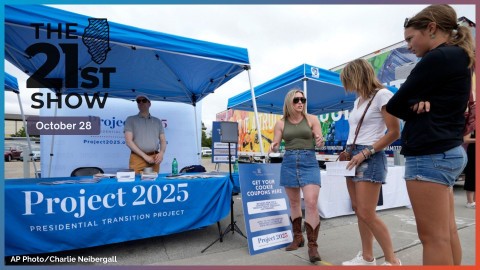 Kristen Eichamer, center, talks to fairgoers in the Project 2025 tent at the Iowa State Fair, Aug. 14, 2023, in Des Moines, Iowa.