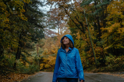 Therese Humphrey Ball walks along the hilly and tree lined streets of her neighborhood in Ogden Dunes, Indiana, on Oct. 25, 2022. Therese walks daily, rain or shine, up to seven miles, and believes exercise is one of the most important ways to keep healthy when dealing with a multiple sclerosis diagnosis. 