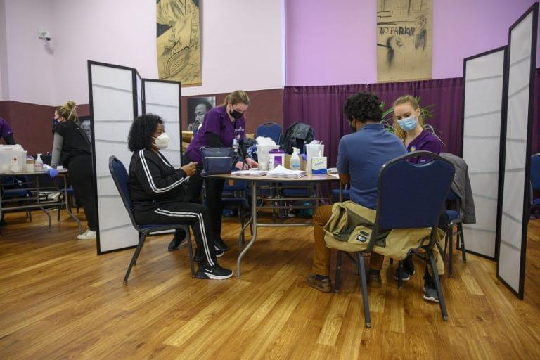 Several people get the COVID-19 vaccine at a mass clinic at the Corinthian Baptist Church in Des Moines. The church was intentionally selected for the clinic as a safe space for many members of the Black community to get vaccinated.
