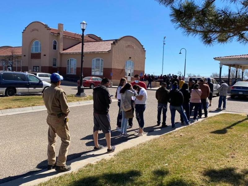 The families of National Beef meatpacking plant employees wait in line for COVID-19 vaccinations in Liberal, Kansas.