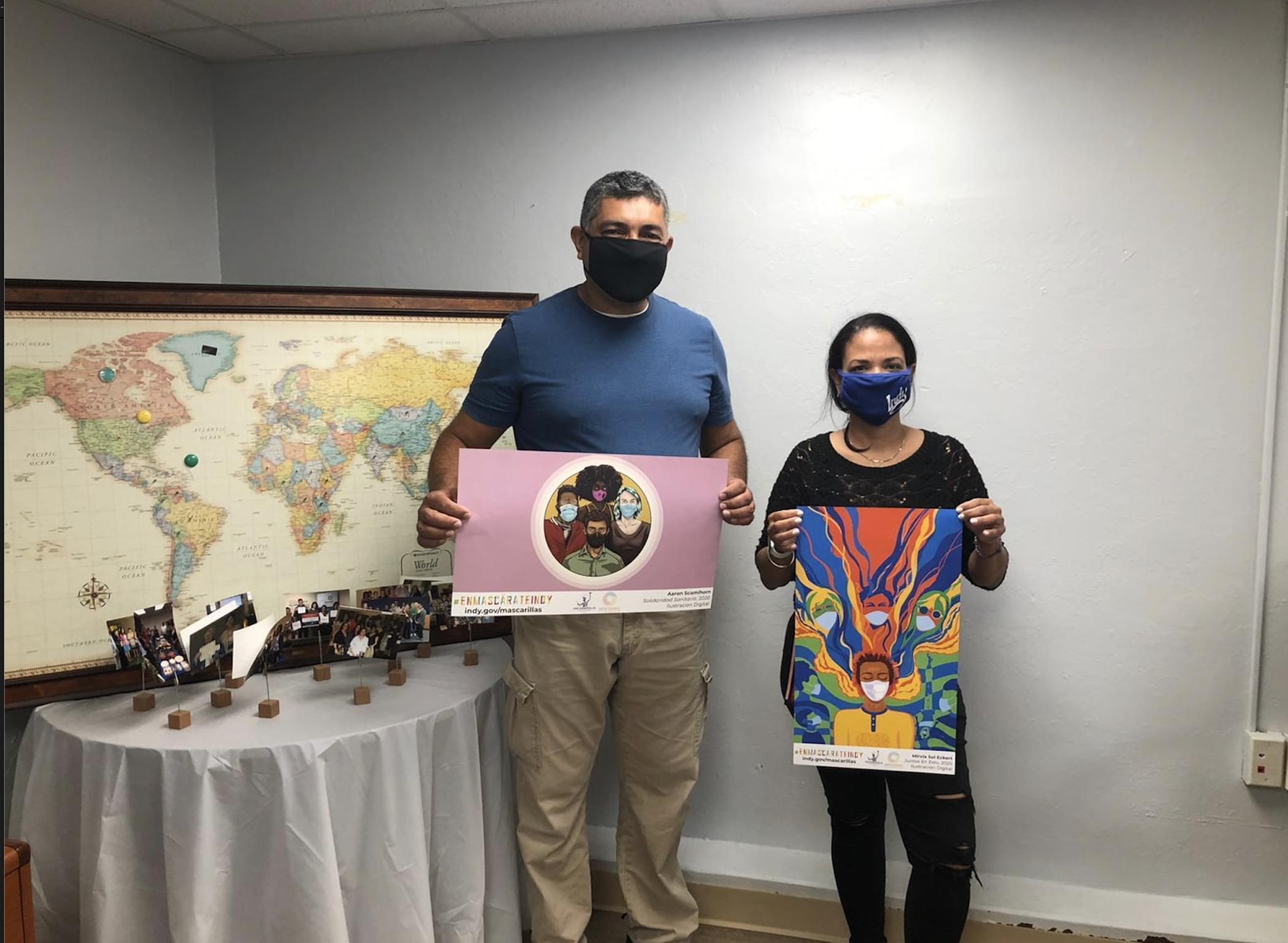 Two Natural Helper Specialists, Francisco Ruiz and Virna Diaz, collecting Mask Up posters to distribute to immigrant-owned businesses for COVID-19 prevention.