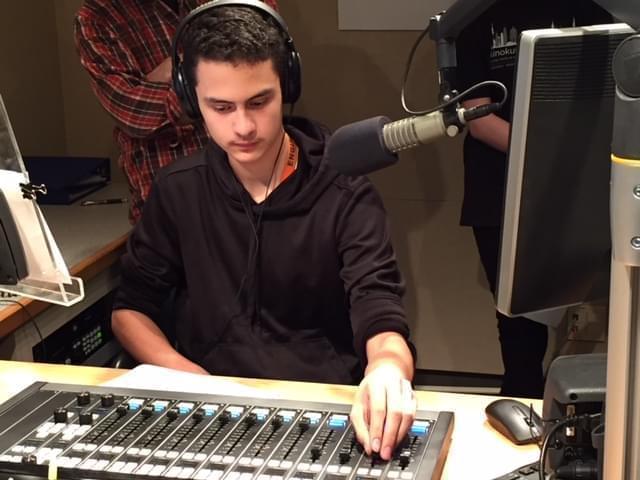 Uni High student Ivan Favila adjusts recording levels in the WILL studio.